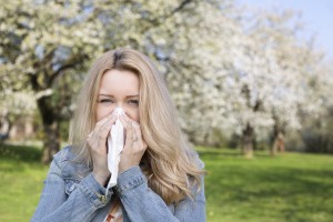 iStock_000063490289_Large-1 woman sneezing in a park